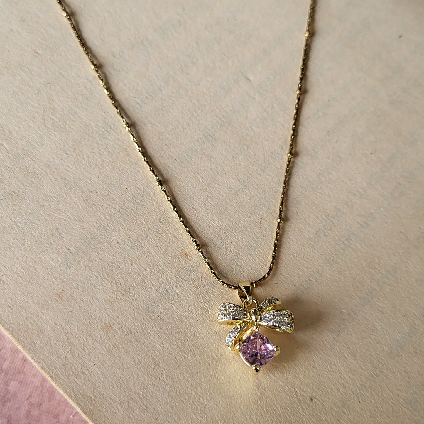 Pink bow pendant chain